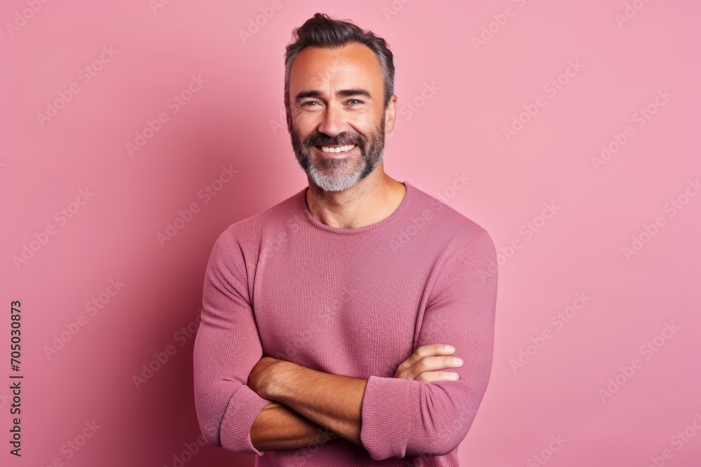 Portrait of a handsome middle-aged man with a beard on a pink background Portrait of a handsome middle-aged man with a beard on a pink background