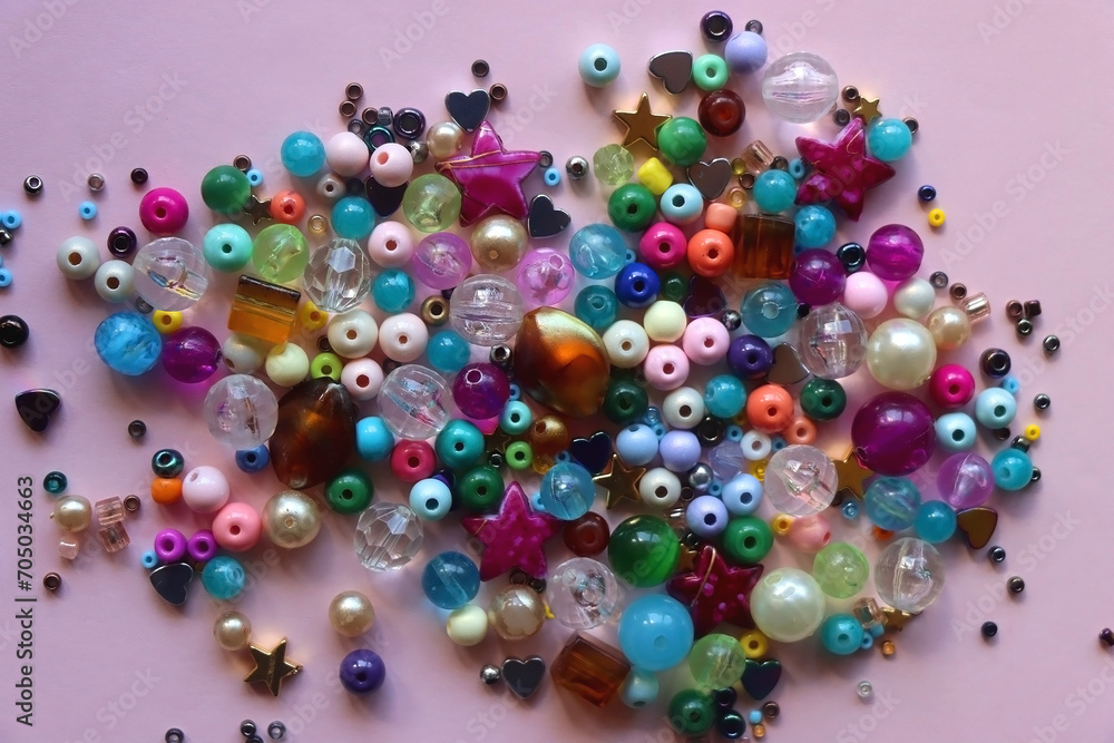 Various colorful beads on bright pink background. Top view. Various colorful beads on bright pink background. Top view.