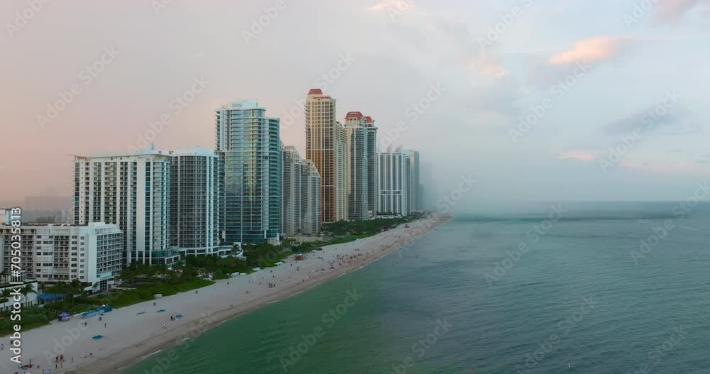 Aerial view of tourists running from beach during approaching storm at ocean shore in Sunny Isles Beach city. Bad weather spoiling vacation time Aerial view of tourists running from beach during approaching storm at ocean shore in Sunny Isles Beach city. Bad weather spoiling vacation time