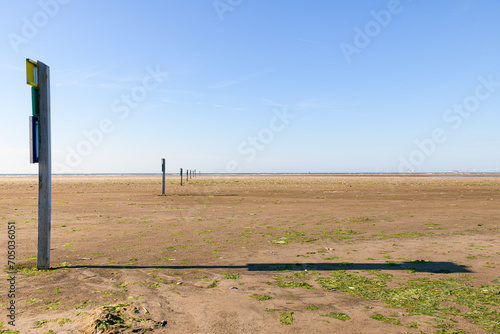 Poles with no entry signs for the protection of nesting birds at the beach Kwade Hoek near Ouddorp on the island Goeree-Overflakkee in the Netherlands. photo