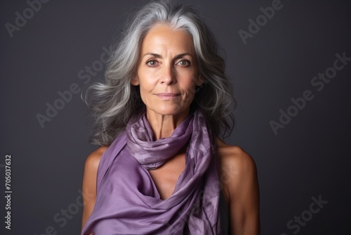 Portrait of a beautiful senior woman with gray hair and purple scarf