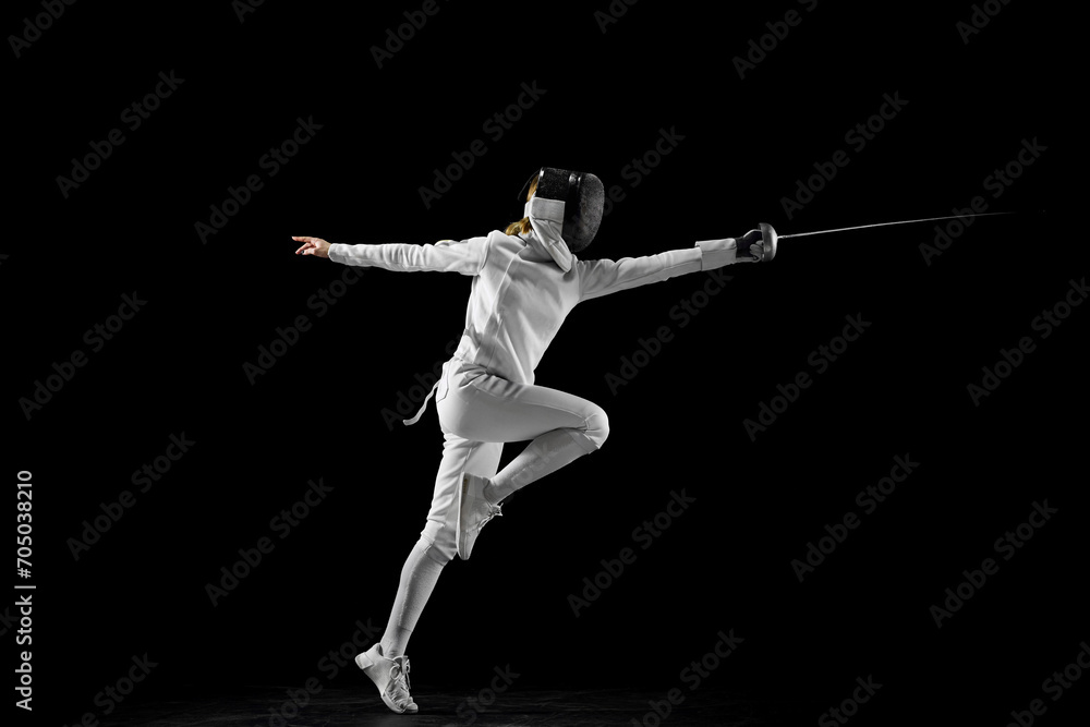 Confidence and strength. Female athlete in fencing gear showcasing her