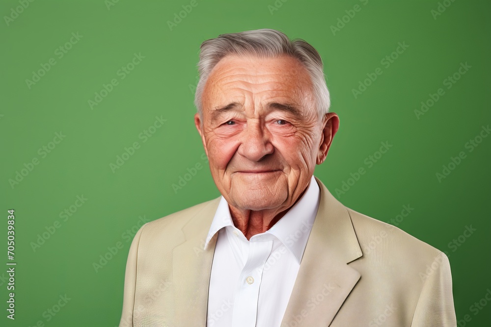 Portrait of a senior man with grey hair on a green background Portrait of a senior man with grey hair on a green background