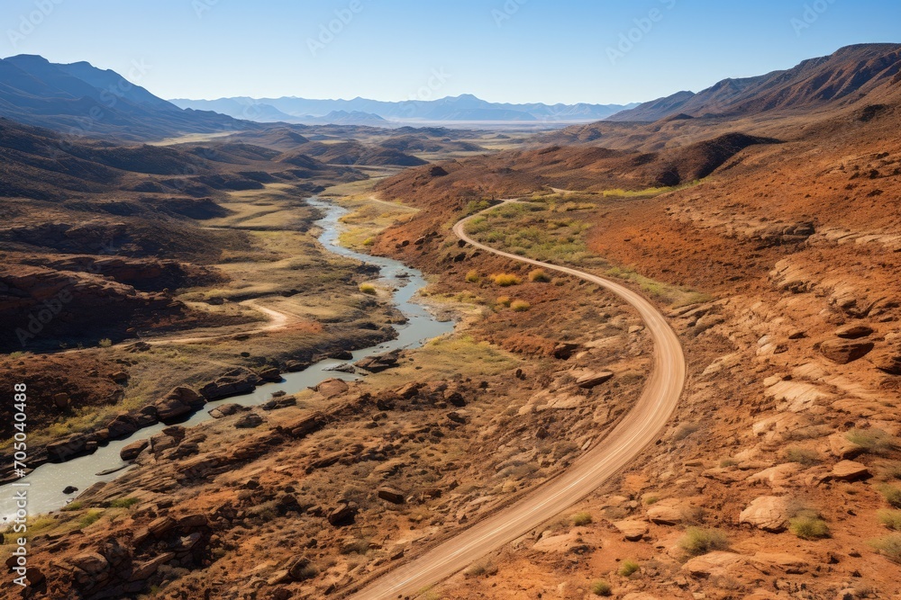 Aerial view of a dirt road to the mountains