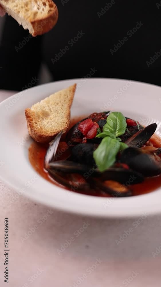 A girl is eating mussels. Close-up A girl is eating mussels. Close-up