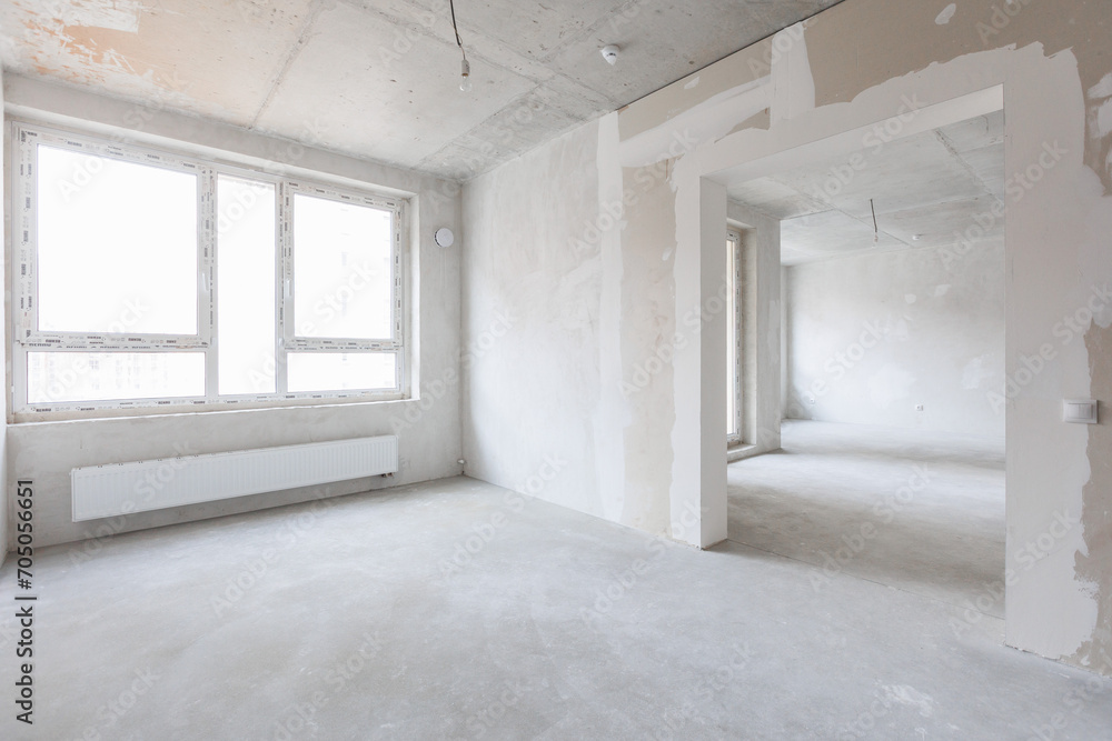 Fototapeta premium interior of the apartment without decoration in gray colors. rough finish