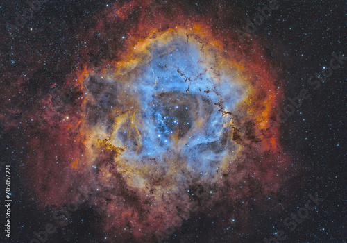 NGC 2244 and NGC 2237 (The Rosette Nebula) in the constellation of Monoceros, 5200 light years away from us. It takes light 65 years to travel from one side to the other side in this nebula. © Kasra