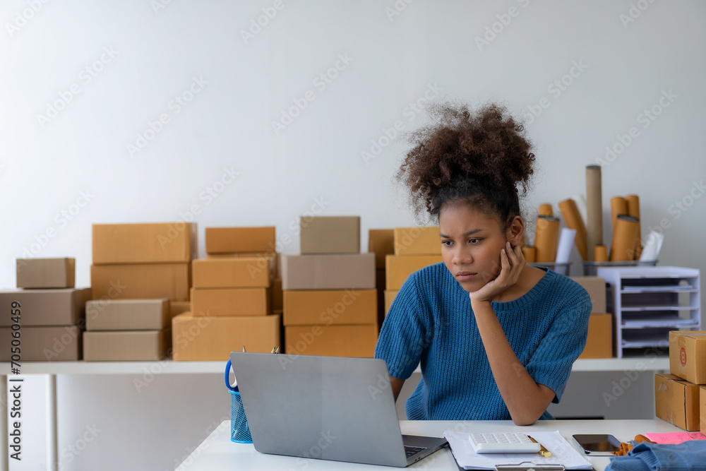 African businesswoman makes a stressed face with bad online sales idea The leading supplier of custom packaging creates a personalized, fast-paced production experience. SME business concept African businesswoman makes a stressed face with bad online sales idea The leading supplier of custom packaging creates a personalized, fast-paced production experience. SME business concept