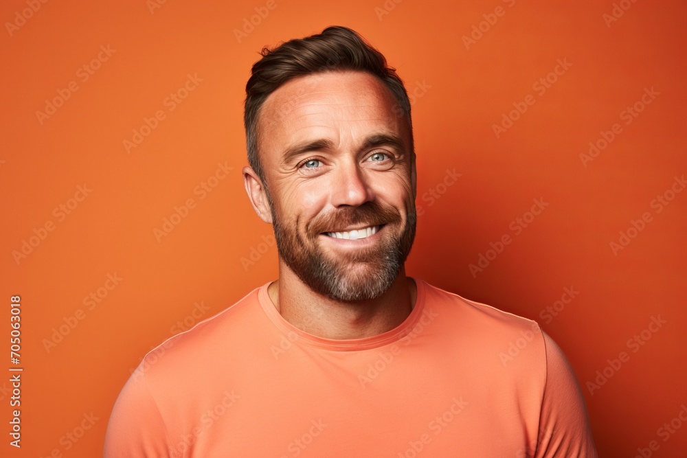 Portrait of a handsome man with beard and mustache on orange background Portrait of a handsome man with beard and mustache on orange background