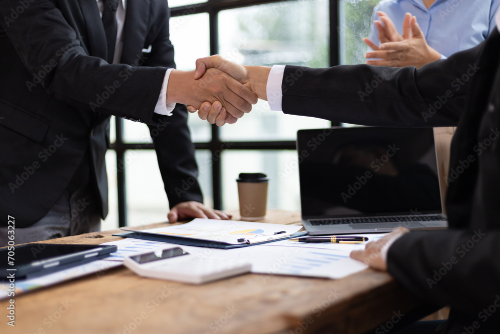 Businessmen shaking hands at a meeting of business partners. Businessmen shaking hands at a meeting of business partners.