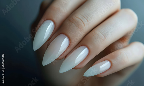 stiletto shaped manicured nails on dark background photo