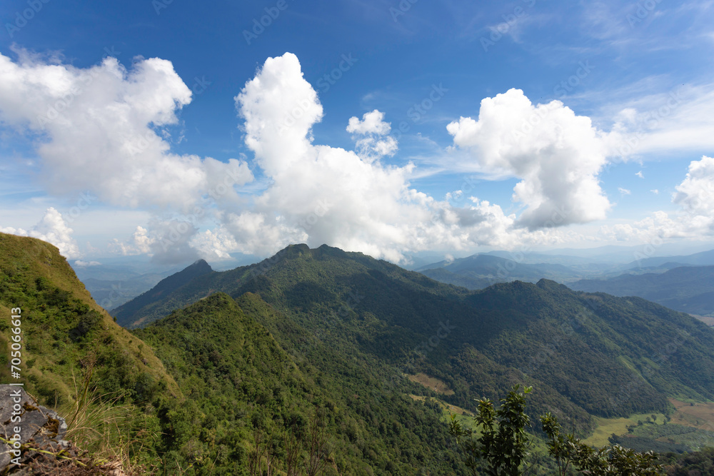Fototapeta premium Mountain forest landscape with beautiful bright sky and clouds