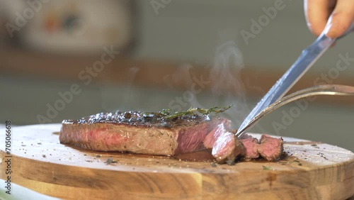 Slicing Steaming Beef Steak On A Cutting Board 4k photo