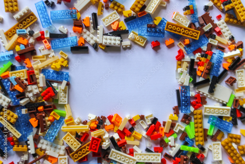 pile of colorful Lego blocks with place for content or text. Top angle view of lego bricks on white background. copy space