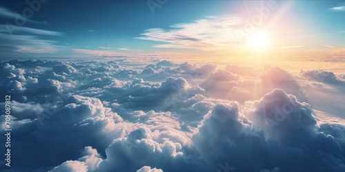 A breathtaking view above the clouds with sunlight piercing through. photo