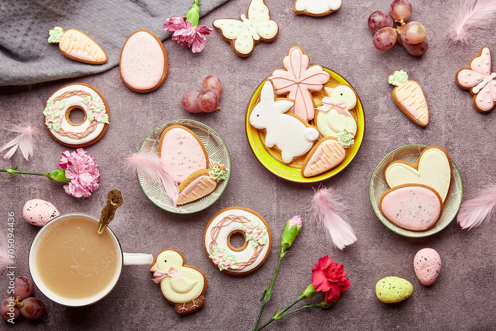Easter aesthetic coffee time flat lay. Decorated glazed cookies, coffee cup, feathers flat lay. Spring stylish background