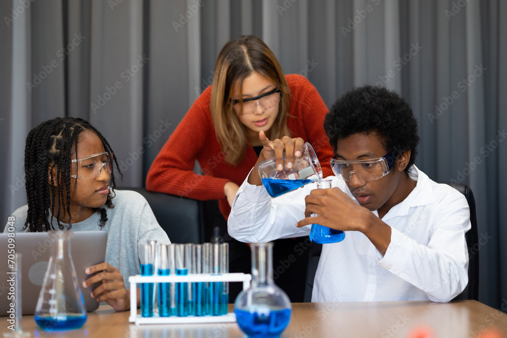 Diversity Teenage boys and girls are doing science experiments with lasks for chemistry in school chemistry classroom. chemistry class. Diverse student sci workshop Diversity Teenage boys and girls are doing science experiments with lasks for chemistry in school chemistry classroom. chemistry class. Diverse student sci workshop