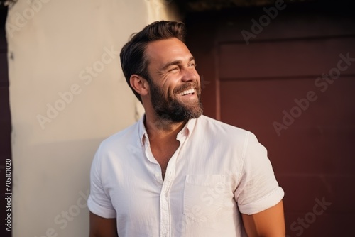 Portrait of a handsome young man laughing and looking at the camera