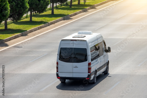 Passenger white minibus accelerating ride on highway photo