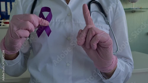 Purple ribbon awareness in doctor hand for ADD and ADHD cancer photo