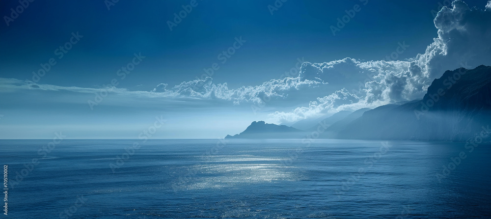 Blue sky with mountain scenery and calm sea