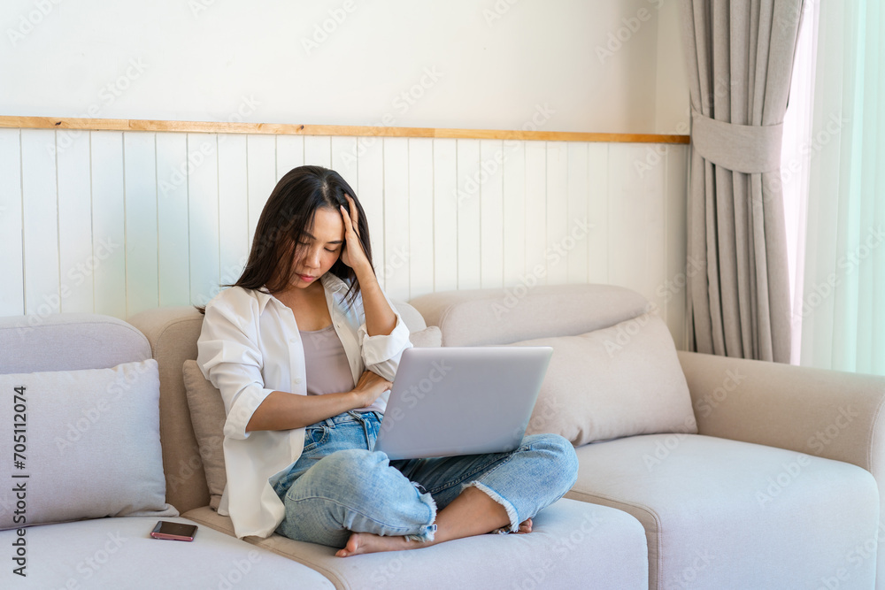 Tired and stressed young woman with laptop at home, Freelance working Tired and stressed young woman with laptop at home, Freelance working