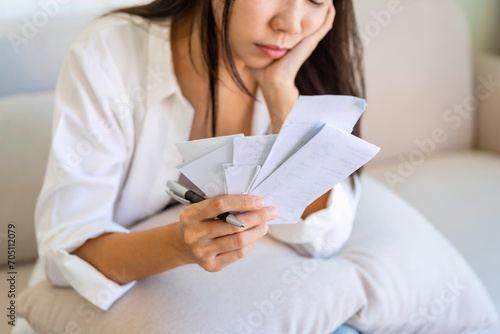 Stressed woman calculating and planning household expenses and bills reflecting financial strain during a recession