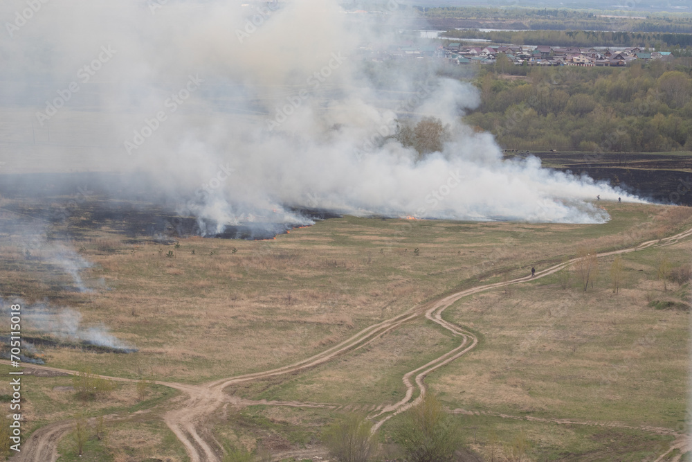 Burning fields. Ecology disaster - Wildfire. Aerial view Burning fields. Ecology disaster - Wildfire. Aerial view