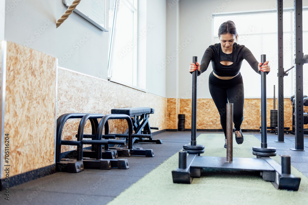 Fototapeta premium Fit young woman has training at a crossfit style