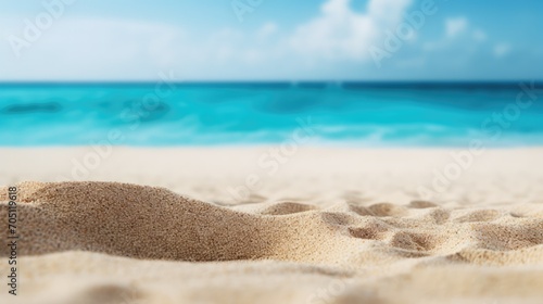 Close-up of sandy beach with clear blue ocean horizon. Summer vacation and travel.