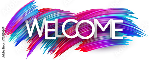 Welcome paper word sign with colorful spectrum paint brush strokes over white.