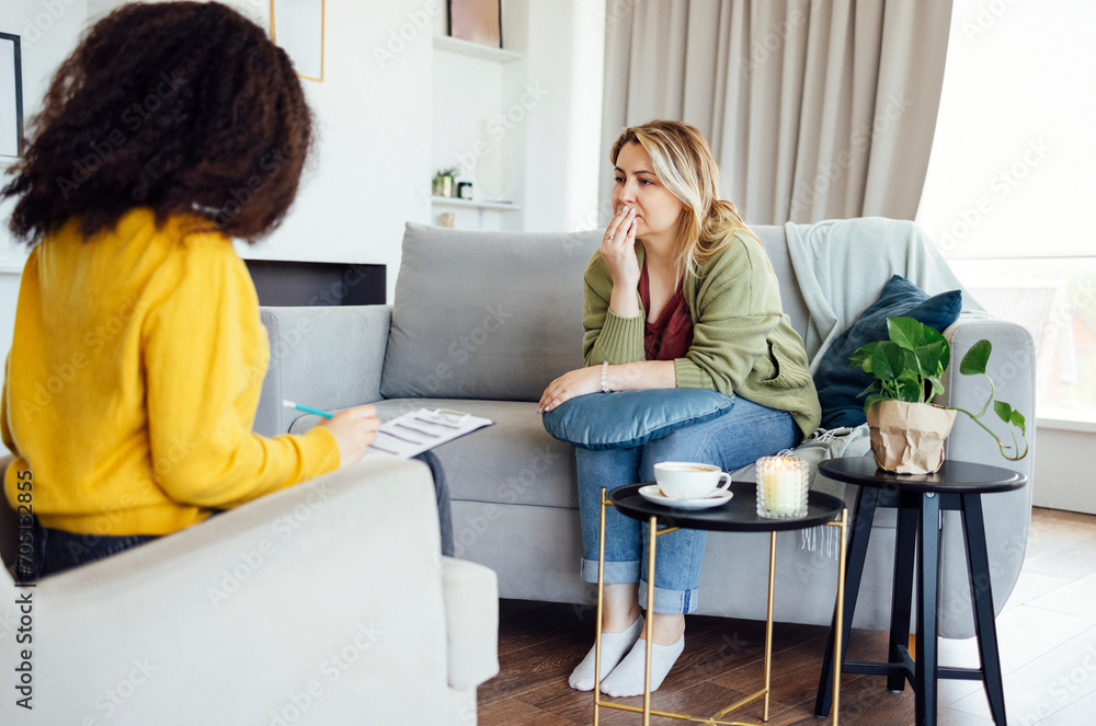 © Dasha Petrenko - Female African American psychotherapist offering female middle age client