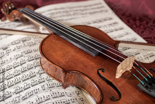 Beautiful closeup shot of a classic violin, with its wooden body and bow.
