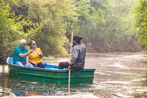 Photography Senior couple tourist traveling on boat at lake