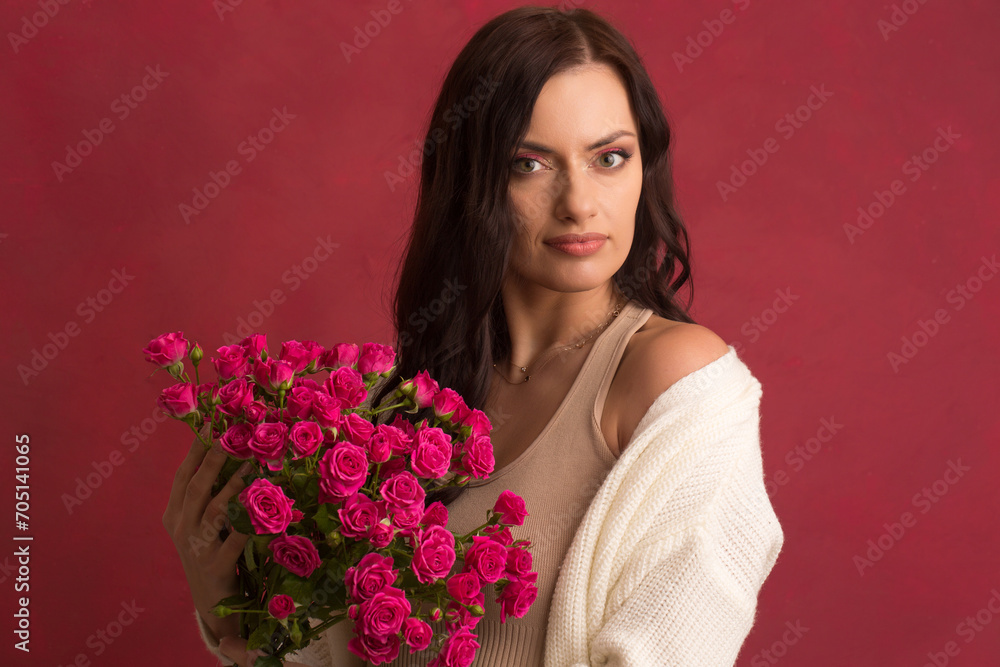 Beautiful woman with a bouquet of small pink roses Beautiful woman with a bouquet of small pink roses