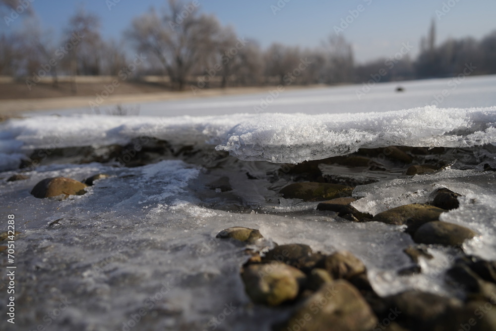 A layer of ice covered the small town lake. A layer of ice covered the small town lake.