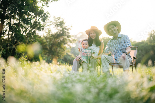 happy harmonious family outdoors concept father and mother and son have activities together on holidays, nature grassland field