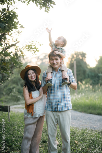 happy harmonious family outdoors concept father and mother and son have activities together on holidays, nature grassland field