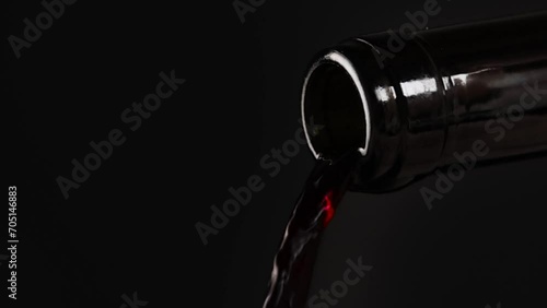 Red wine is pouring out of the bottle photo