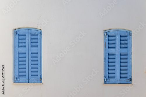Blue window shutters on a white wall