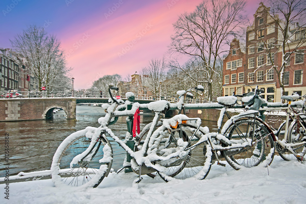 snowy Amsterdam in the Netherlands at sunset
