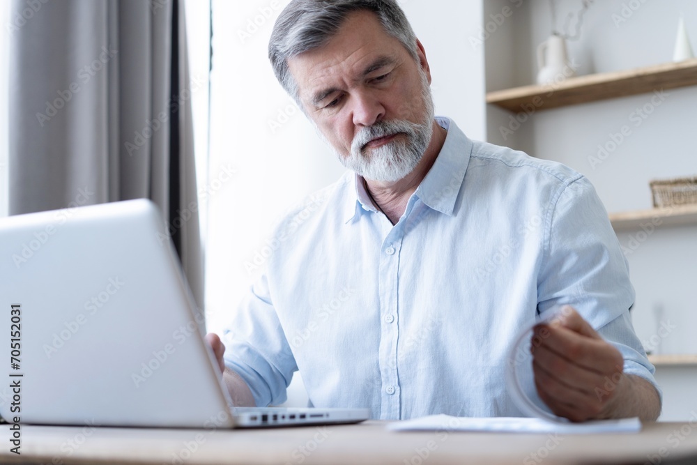 Man working on laptop from home. Counting financial data. Man working on laptop from home. Counting financial data.