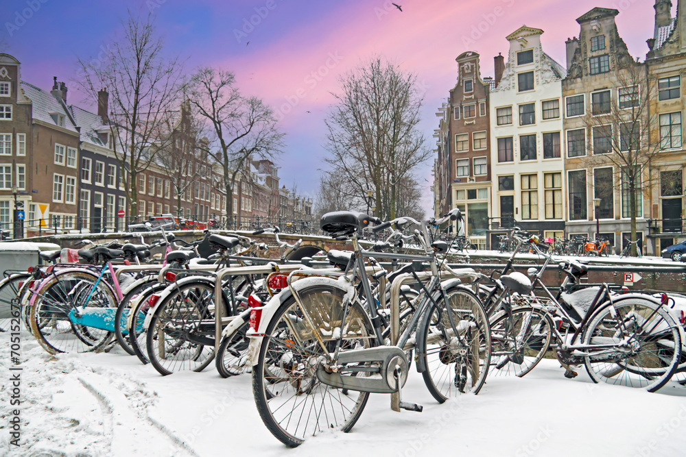 Snowy bikes in Amsterdam the Netherlands at sunset