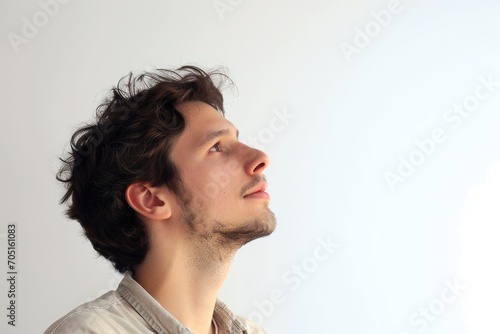 Wistful portrait of a man gazing into the distance, white background