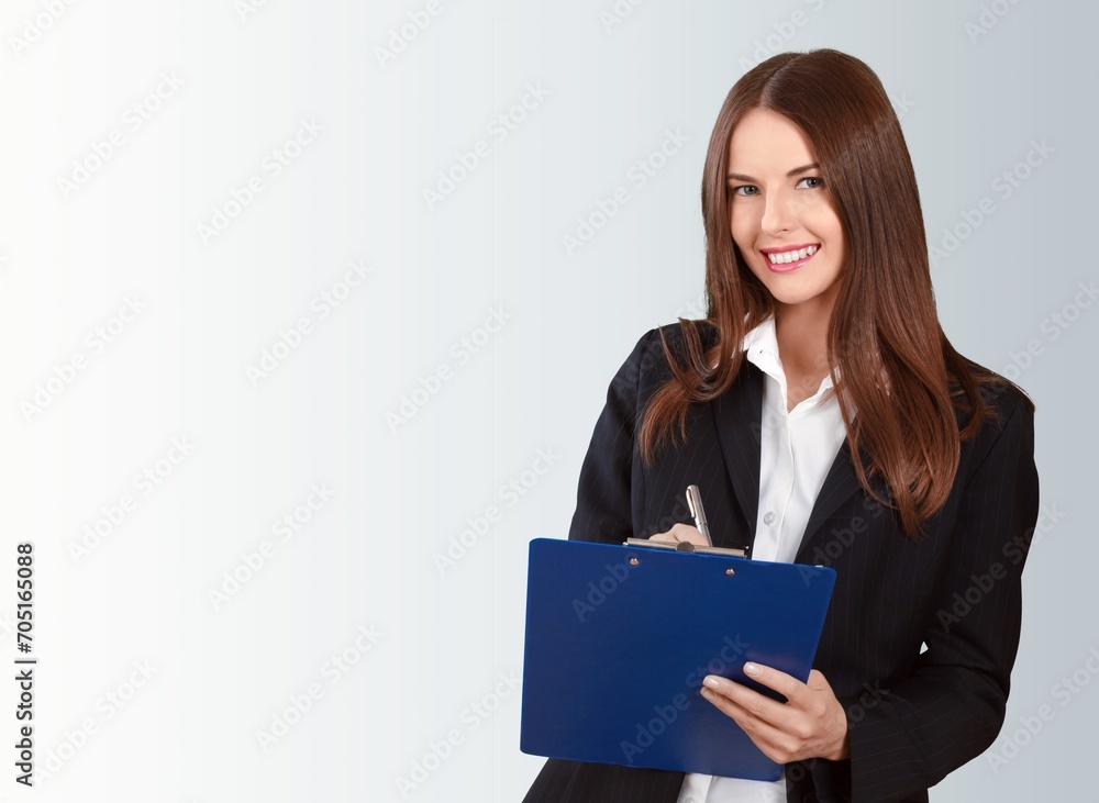 Young happy female standing holding documents Young happy female standing holding documents