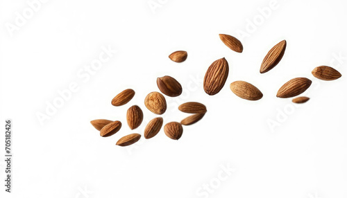 Almonds fall in pile on light gray background. Creative concept of floating healthy snacks. Levitation of nuts. Close-up. Copy space.