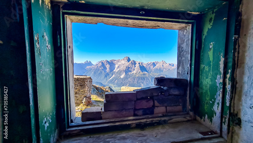 View from window of remains of military bunker First World War, mount Hornischegg. Looking at peak Dreischusterspitze in mountain range of untamed Sexten Dolomites, South Tyrol, Austria Italy, Europe photo