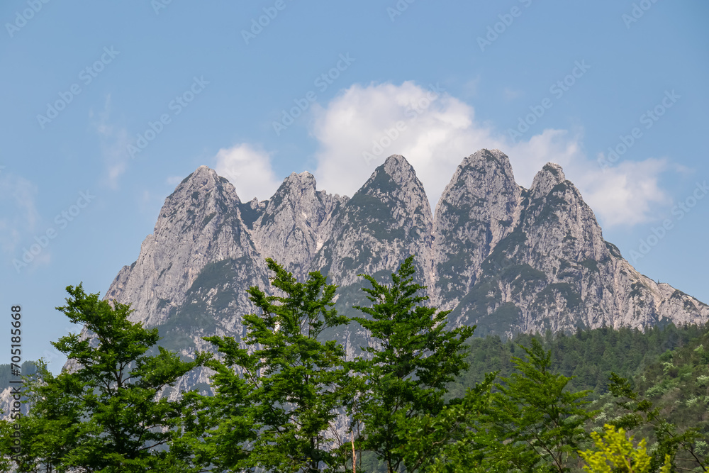 Scenery at Lake Predil with panoramic view of majestic mountain peak Cinque Punte, Tarvisio, Friuli Venezia Giulia, Italy. Tranquil scene in summer. Alpine landscape in Julian Alps, border Slovenia