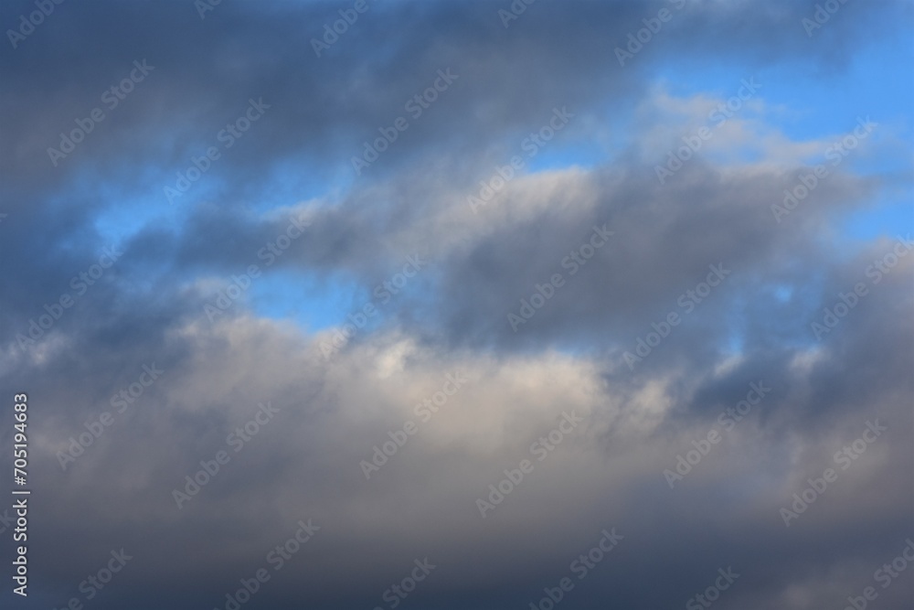 Cloudscape, Colored Clouds at Sunset near the Ocean on a Blue Sky