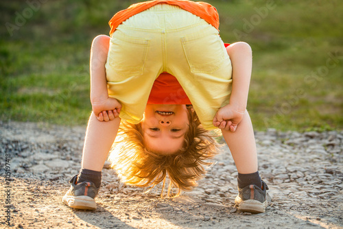 Playing fools kid. Young man happy positive smile playful fooling dance. Cute boy having fun. Child playing. Freedom of self expression and behaviour for kids. Happy cute child standing upside down photo